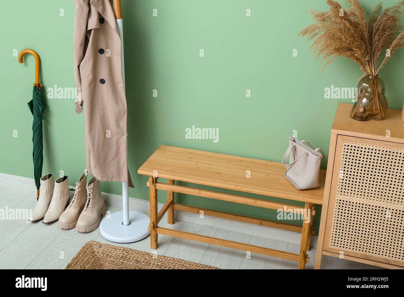 Interior of modern hall with bench, rack and drawers Stock Photo - Alamy
