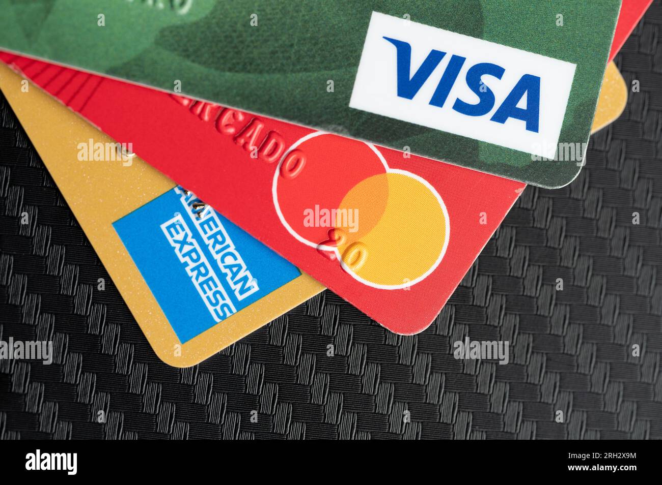 New York, USA - August 2, 2023: Plastic credit cards different color on black table above top view Stock Photo