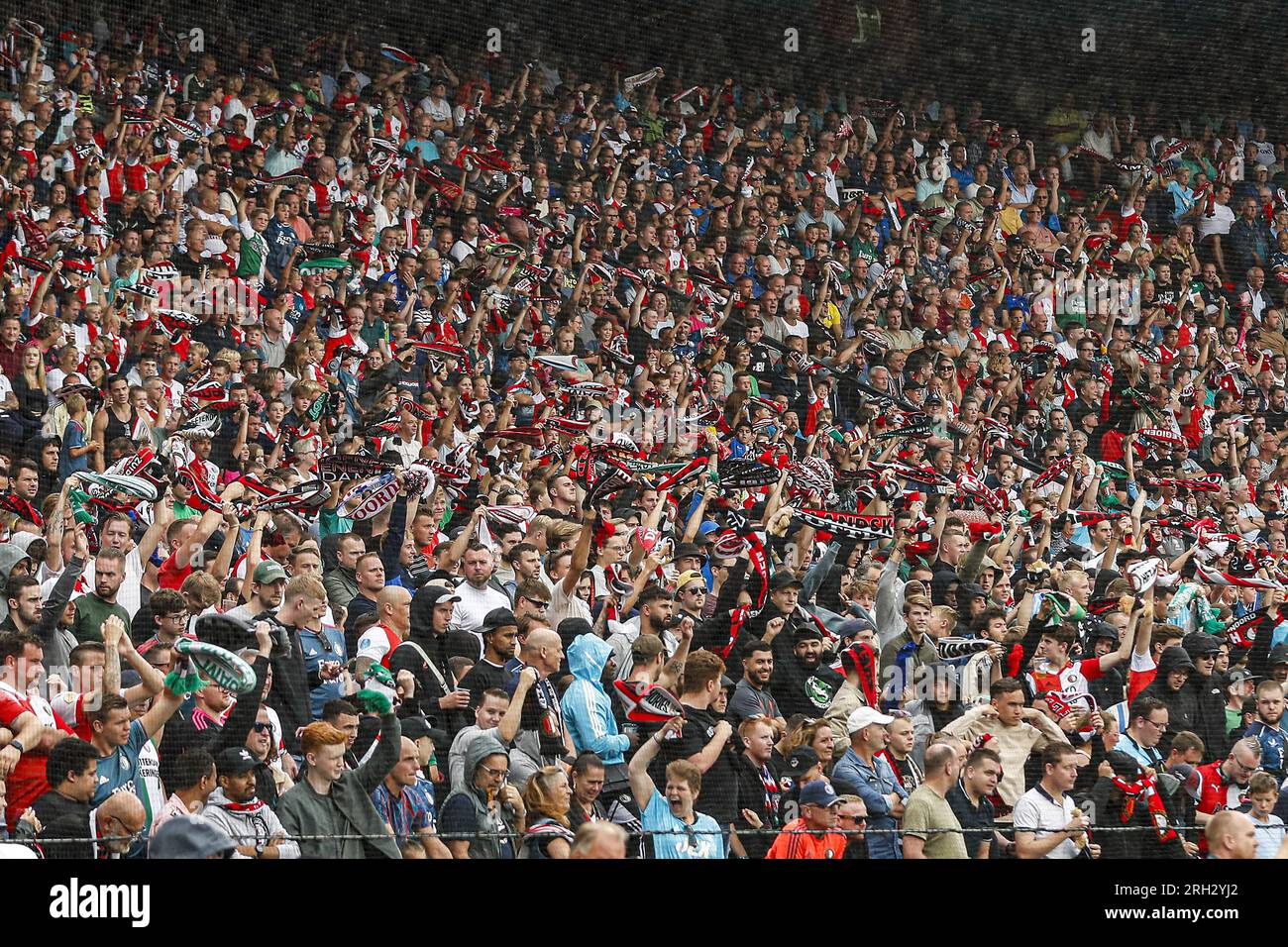 Fans of Ferencvarosi show their support as they hold scarves prior