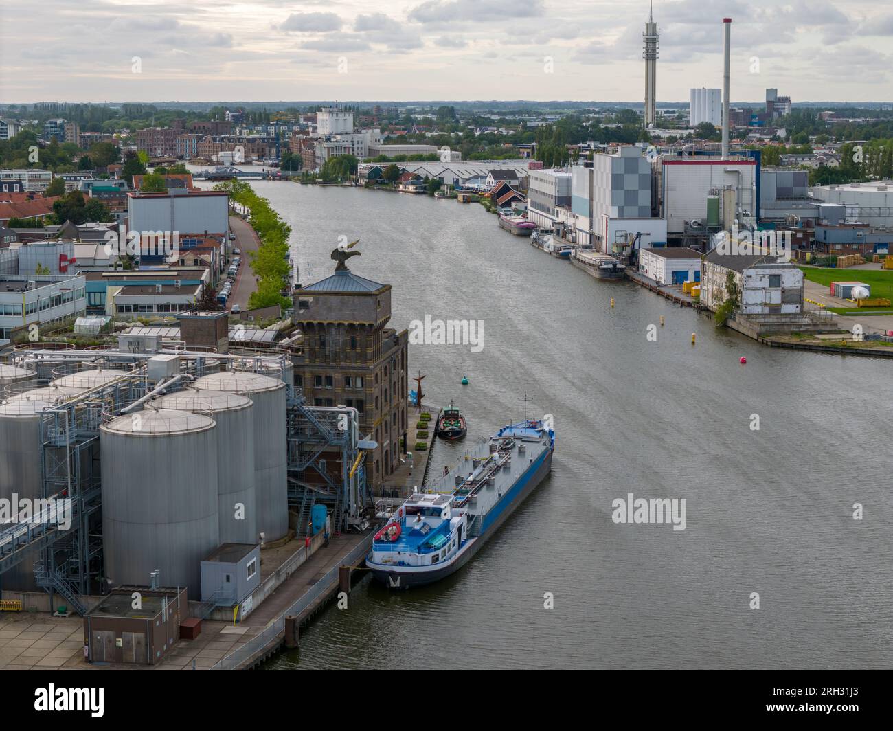 Aerial drone photo of a cargo barge docked at an industrial zone in Wormerveer, the Netherlands Stock Photo