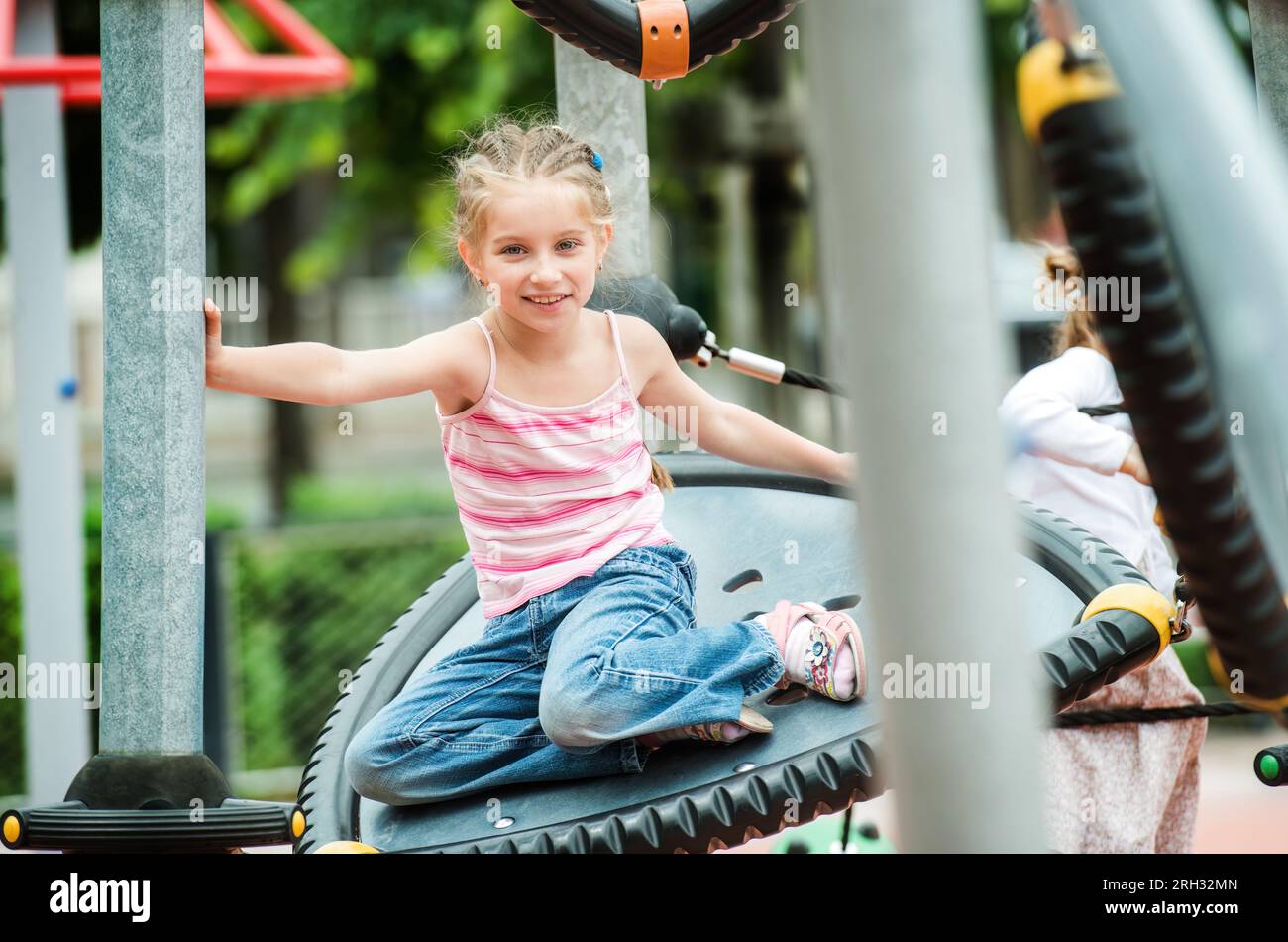 Happy little girl playing at the playground outdoor Stock Photo - Alamy