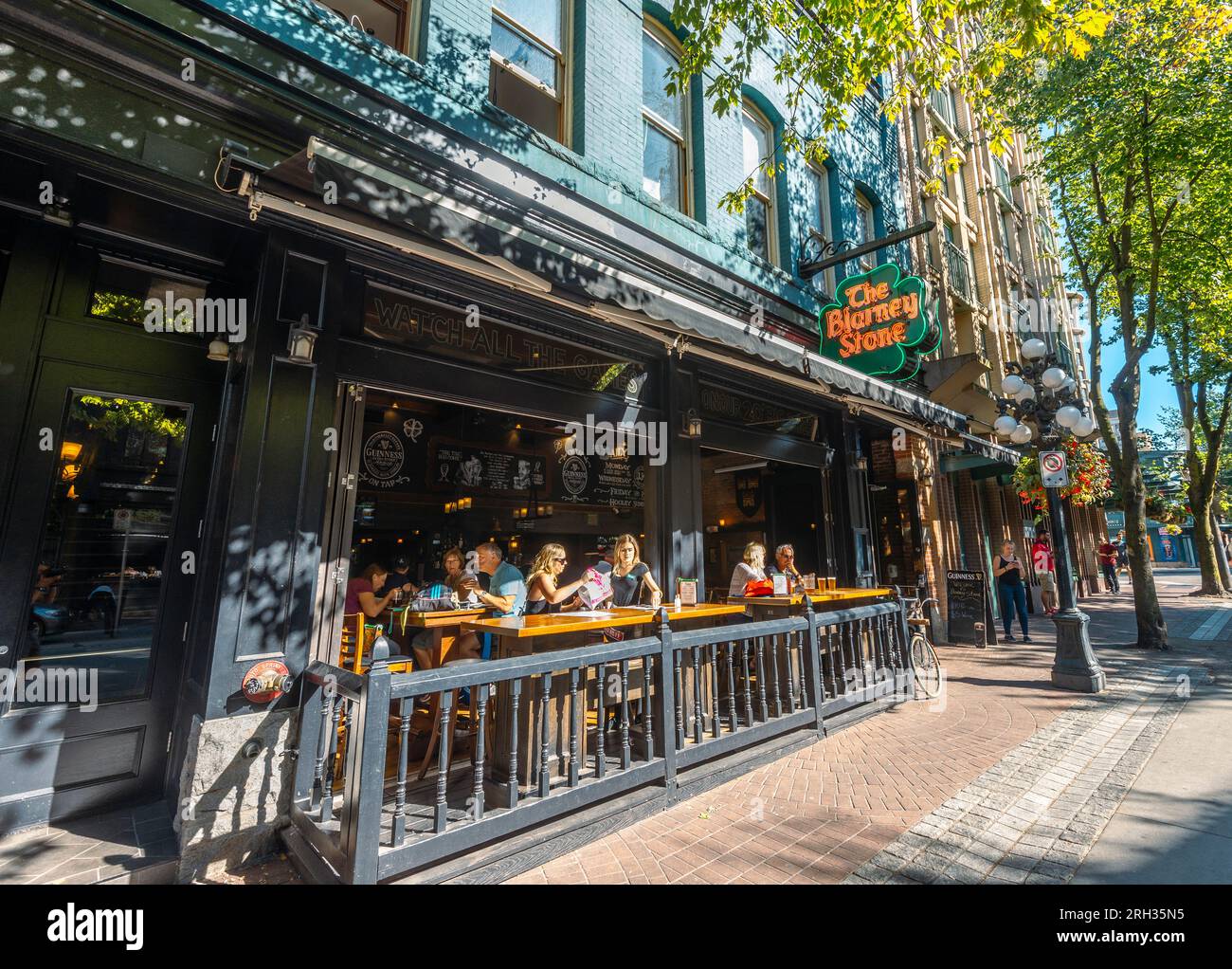 People enjoying some drinks in the sunshine on a summers day in Gastown