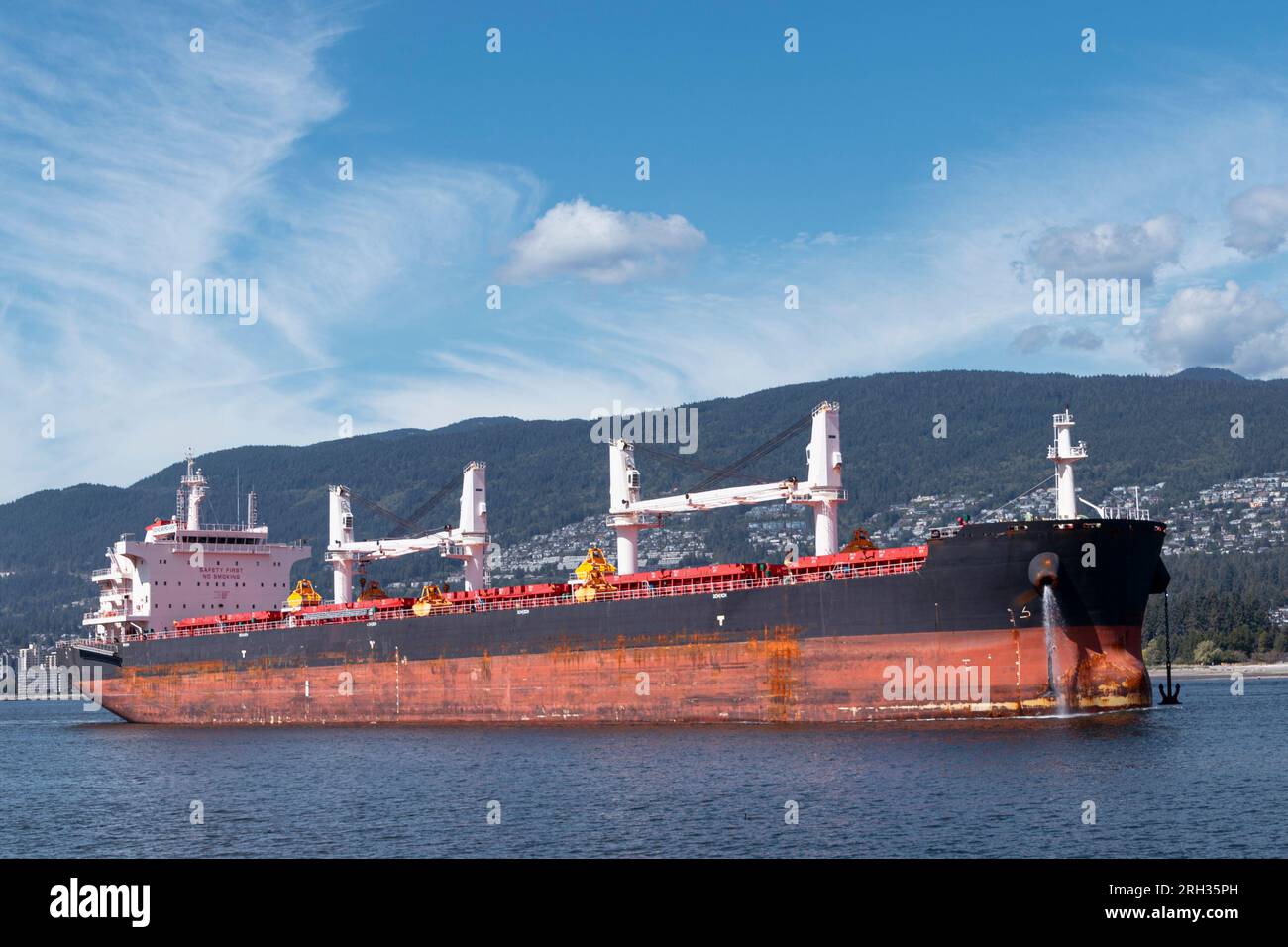 A supertanker navigates its way into Inner Vancouver harbour near Lions Gate Bridge in Canada Stock Photo