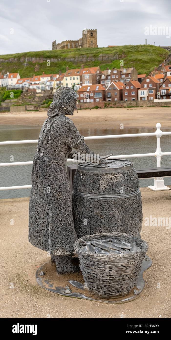 The Herring Girl statuette on the quayside of Whitby harbour on the North Yorkshire coast Stock Photo