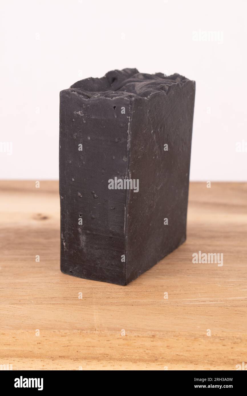 Charcoal soap on wood board Stock Photo