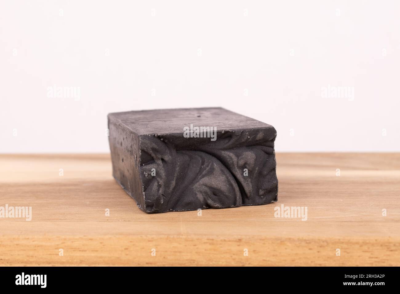 Charcoal soap on wood board Stock Photo