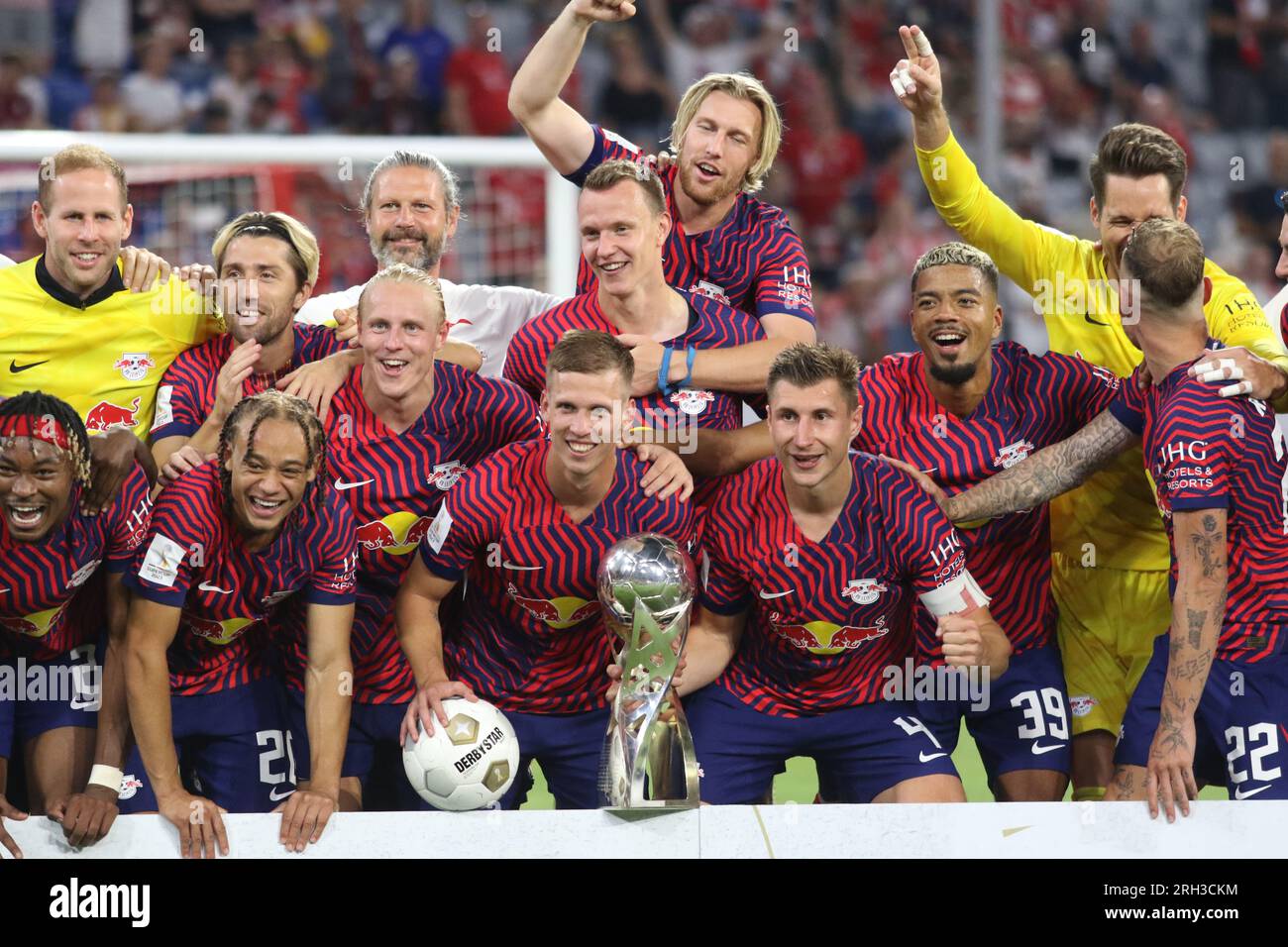 MUNICH, Germany - 12. AUGUST 2023: 4 Willi Orban (C) with trophy, RB Leipzig players celebrate with the winners trophy after winning the Supercup 2023 match between FC Bayern München and RB Leipzig at Allianz Arena on August 12th in Munich, Germany. DFL, Fussball, 0:3 (Photo and copyright @ ATP images/Arthur THILL Fc RB-LEIPZIG players and substitutes for this match: 21 Janis Blaswich (Keeper), 2 Mohamed Simakan, 4 Willi Orban (C), 7 Dani Olmo, 11 Timo Werner, 17 Lois Openda, 20 Xavi Simons, 22 David Raum, 24 Xaver Schlager, 39 Benjamin Henrichs, 44 Kevin Kampl, 9 Yussuf Poulsen, 10 Emil Stock Photo