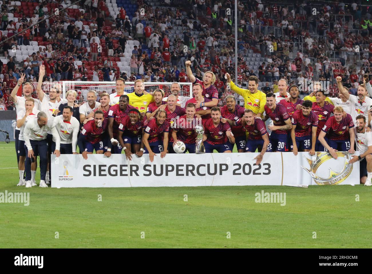 MUNICH, Germany - 12. AUGUST 2023: 4 Willi Orban (C) with trophy, RB Leipzig players celebrate with the winners trophy after winning the Supercup 2023 match between FC Bayern München and RB Leipzig at Allianz Arena on August 12th in Munich, Germany. DFL, Fussball, 0:3 (Photo and copyright @ ATP images/Arthur THILL Fc RB-LEIPZIG players and substitutes for this match: 21 Janis Blaswich (Keeper), 2 Mohamed Simakan, 4 Willi Orban (C), 7 Dani Olmo, 11 Timo Werner, 17 Lois Openda, 20 Xavi Simons, 22 David Raum, 24 Xaver Schlager, 39 Benjamin Henrichs, 44 Kevin Kampl, 9 Yussuf Poulsen, 10 Emil Stock Photo