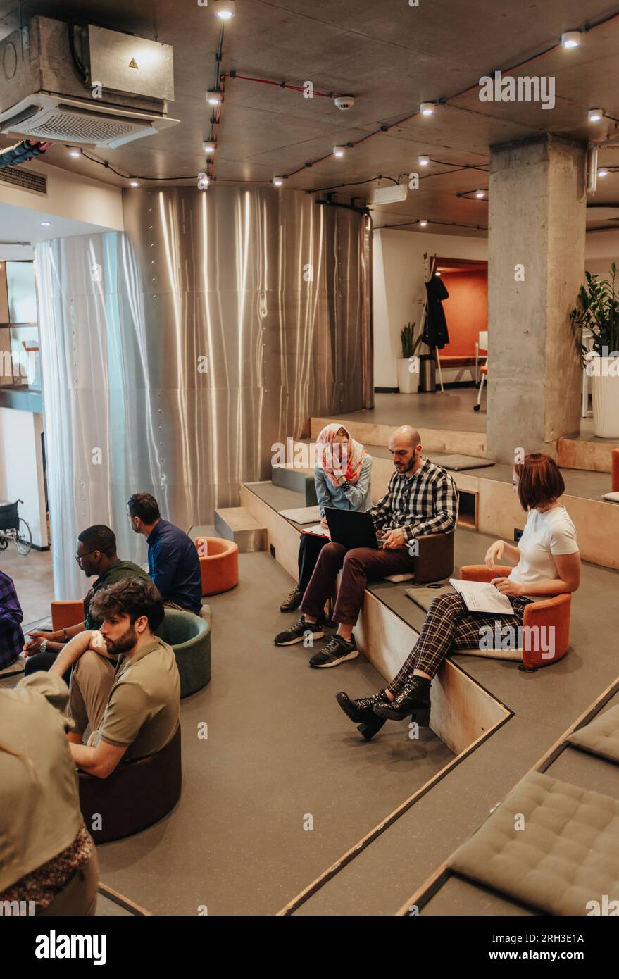 Business employees discussing work during brainstorming at modern co ...