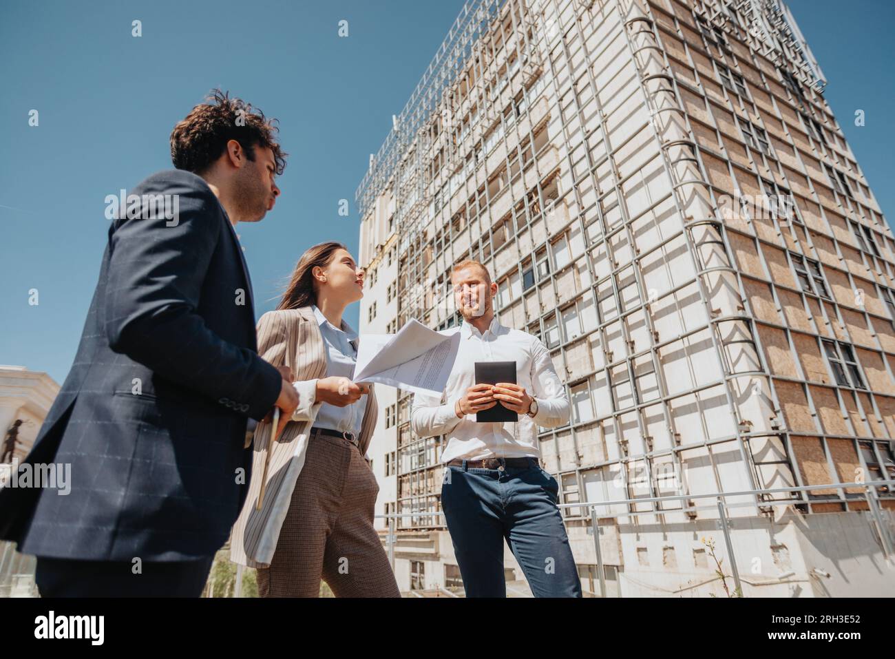 Woman architect explaining project to her male partners during meeting
