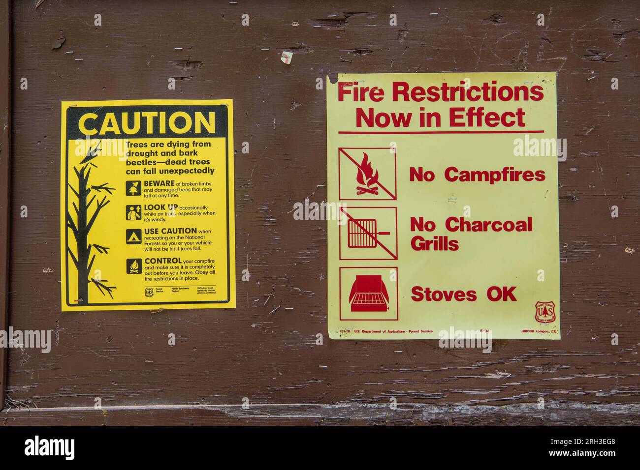 Warning signs in the California wilderness cautioning about Fire restrictions and dying trees. Stock Photo