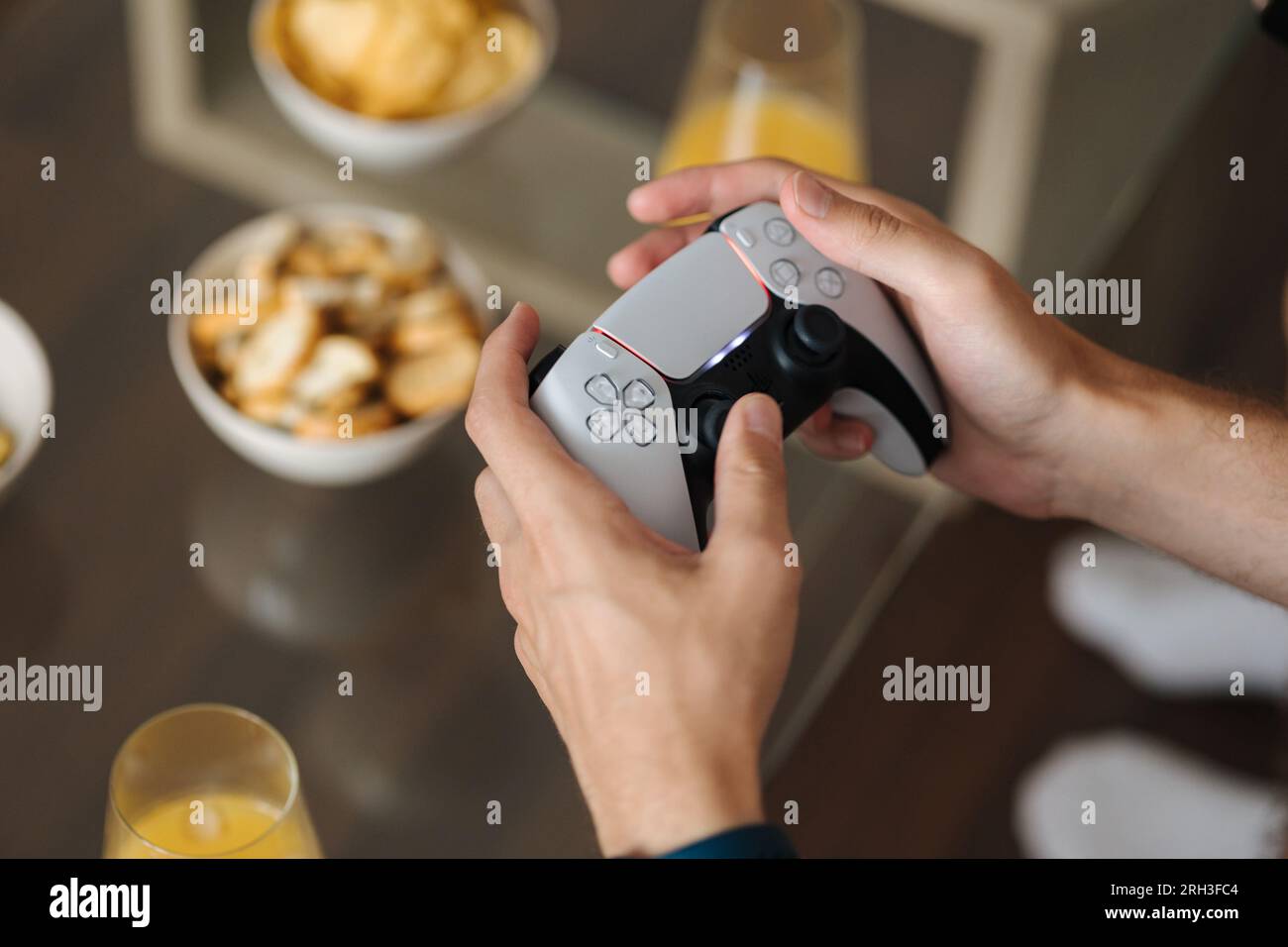 Closeup of human hands use joysticks to play video games on console