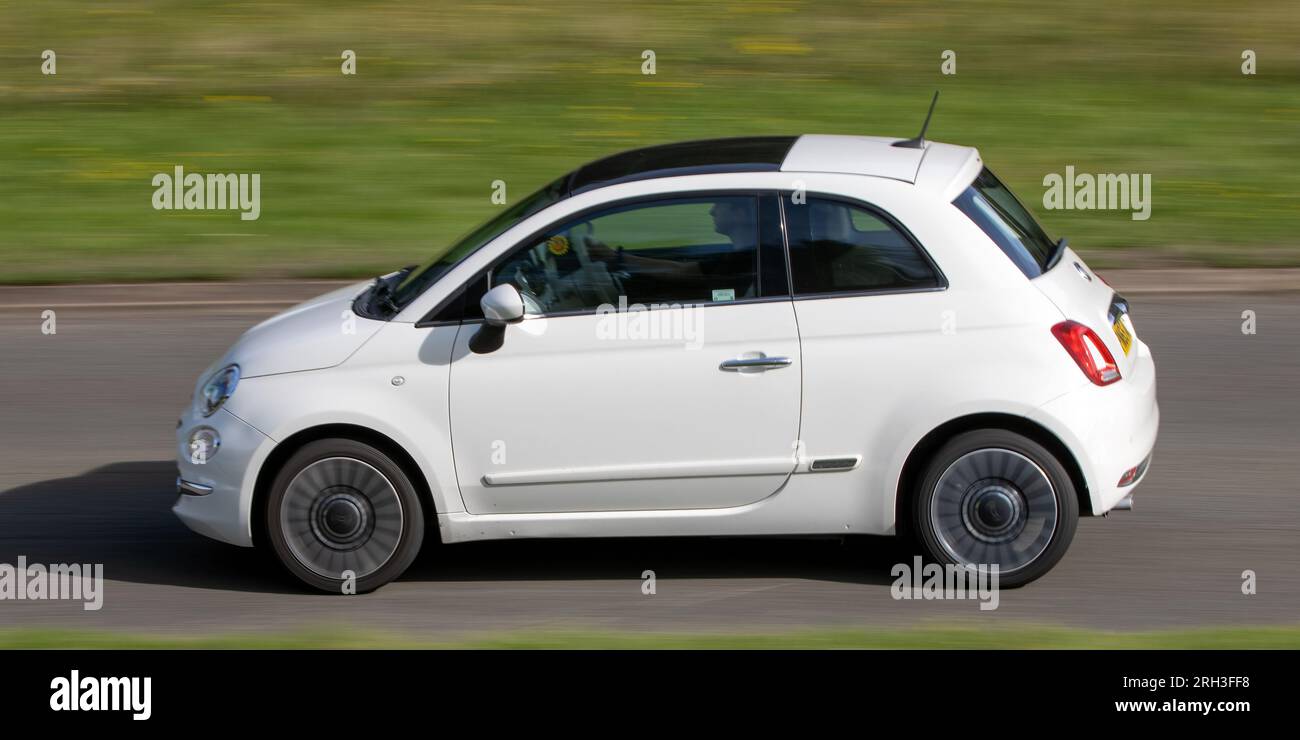 Milton Keynes,UK - Aug 10th 2023: 2015 white Fiat 500 car driving on an English country road. Stock Photo