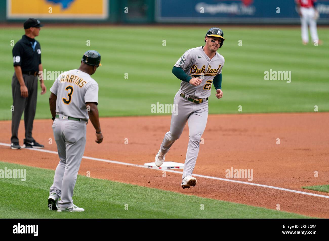 Oakland Athletics' Brent Rooker, right, runs toward home plate after a ...