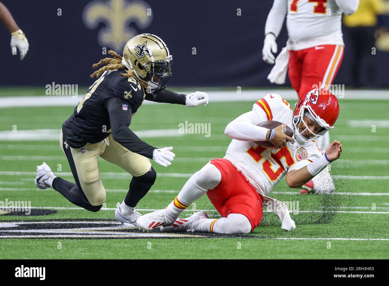 New Orleans, USA. August 13, 2023: Kansas City quarterback Patrick Mahomes (15) slides down in front of Saints defender Bradley Roby (21) during NFL pre-season game action between the New Orleans Saints and the Kansas City Chiefs at the Caesars Superdome in New Orleans, LA. Jonathan Mailhes/CSM (Credit Image: © Jonathan Mailhes/Cal Sport Media) Credit: Cal Sport Media/Alamy Live News Stock Photo