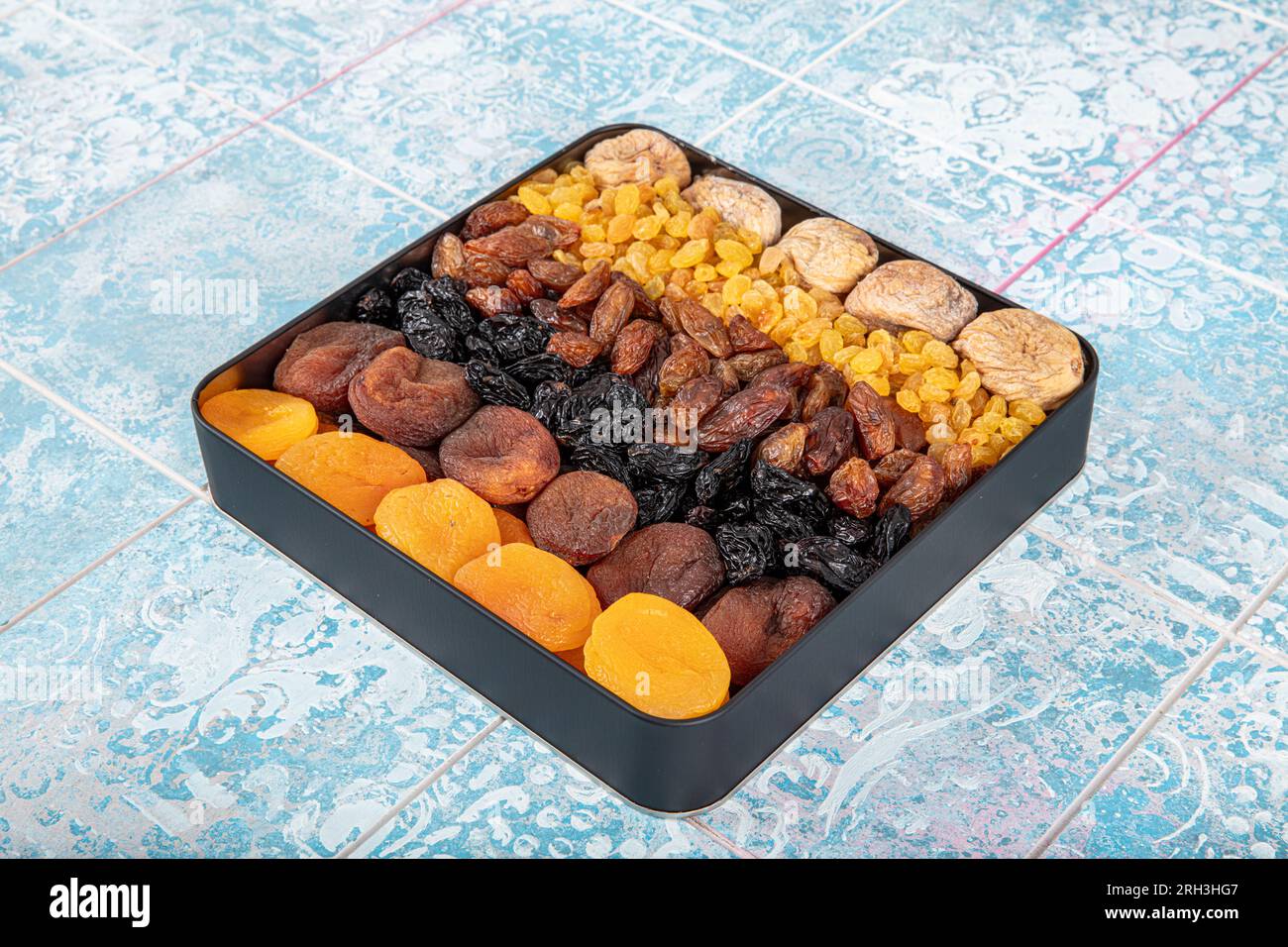 Mixed dried fruits box. Dried fruit background. Rows of dried dates