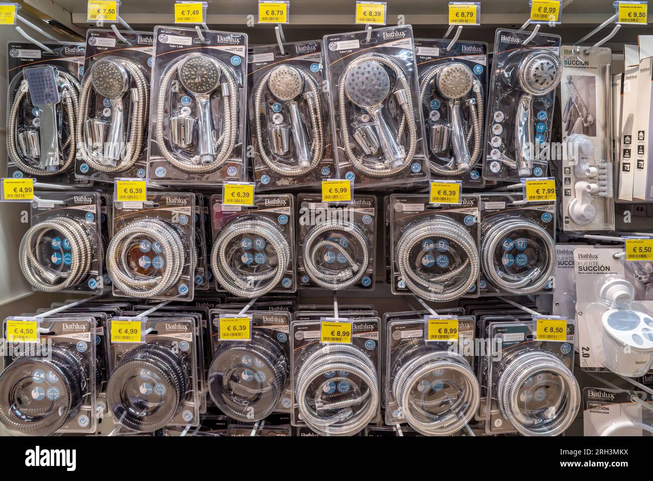 Italy - August 08, 2023: Plumbing accessories, shower heads and flexible hoses displayed on shelf for sale in Italian supermarket Stock Photo