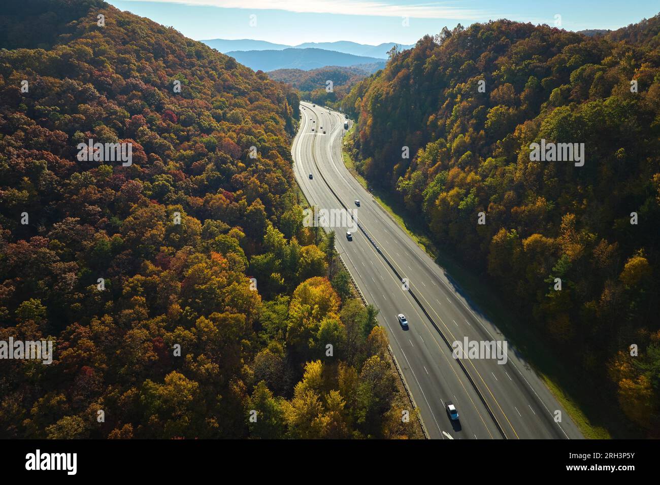Aerial view of I-40 freeway in North Carolina leading to Asheville through Appalachian mountains in golden fall with fast moving trucks and cars Stock Photo