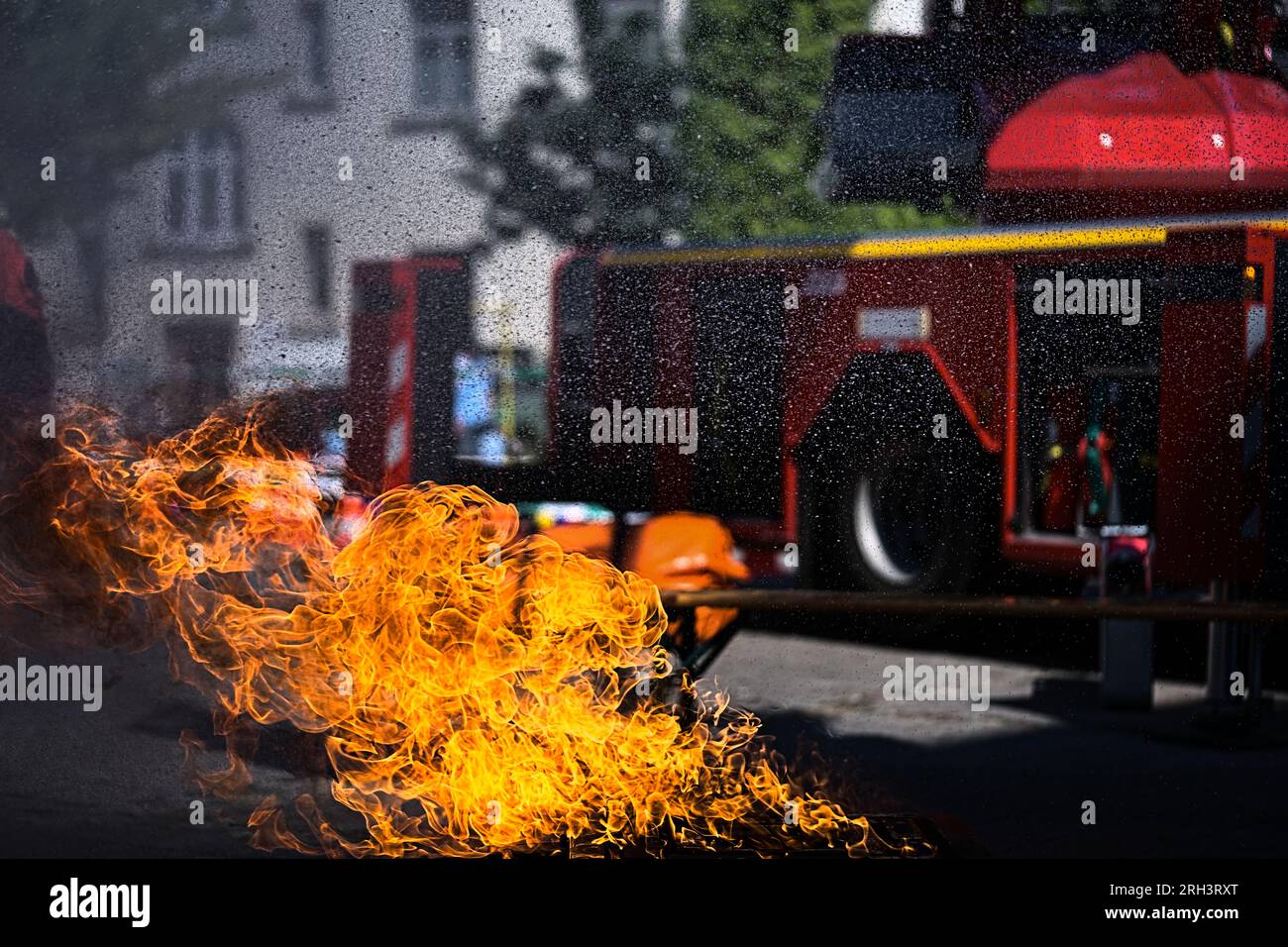 Burning flames fire extinguishing firefighting operation with truck engine Stock Photo