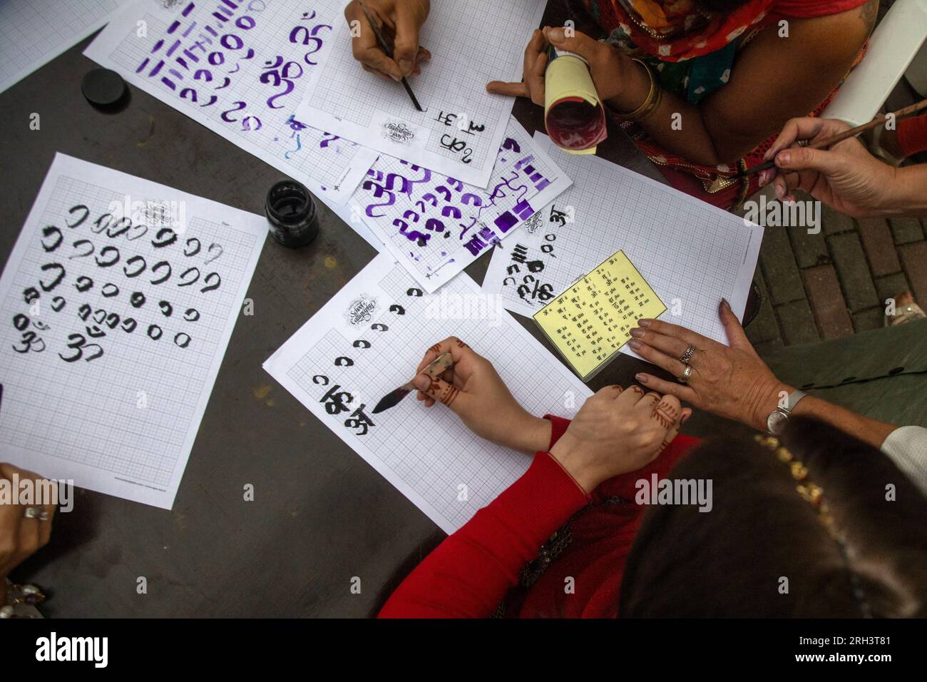 People learn to write letters in Sanskrit Stock Photo