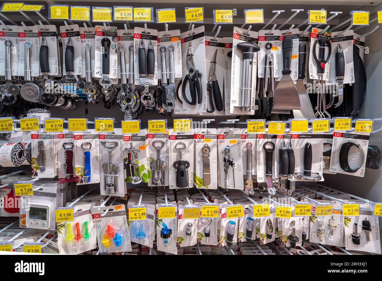 Italy - August 08, 2023: Home tools, corkscrews and can openers displayed on shelf for sale in Italian store market Stock Photo