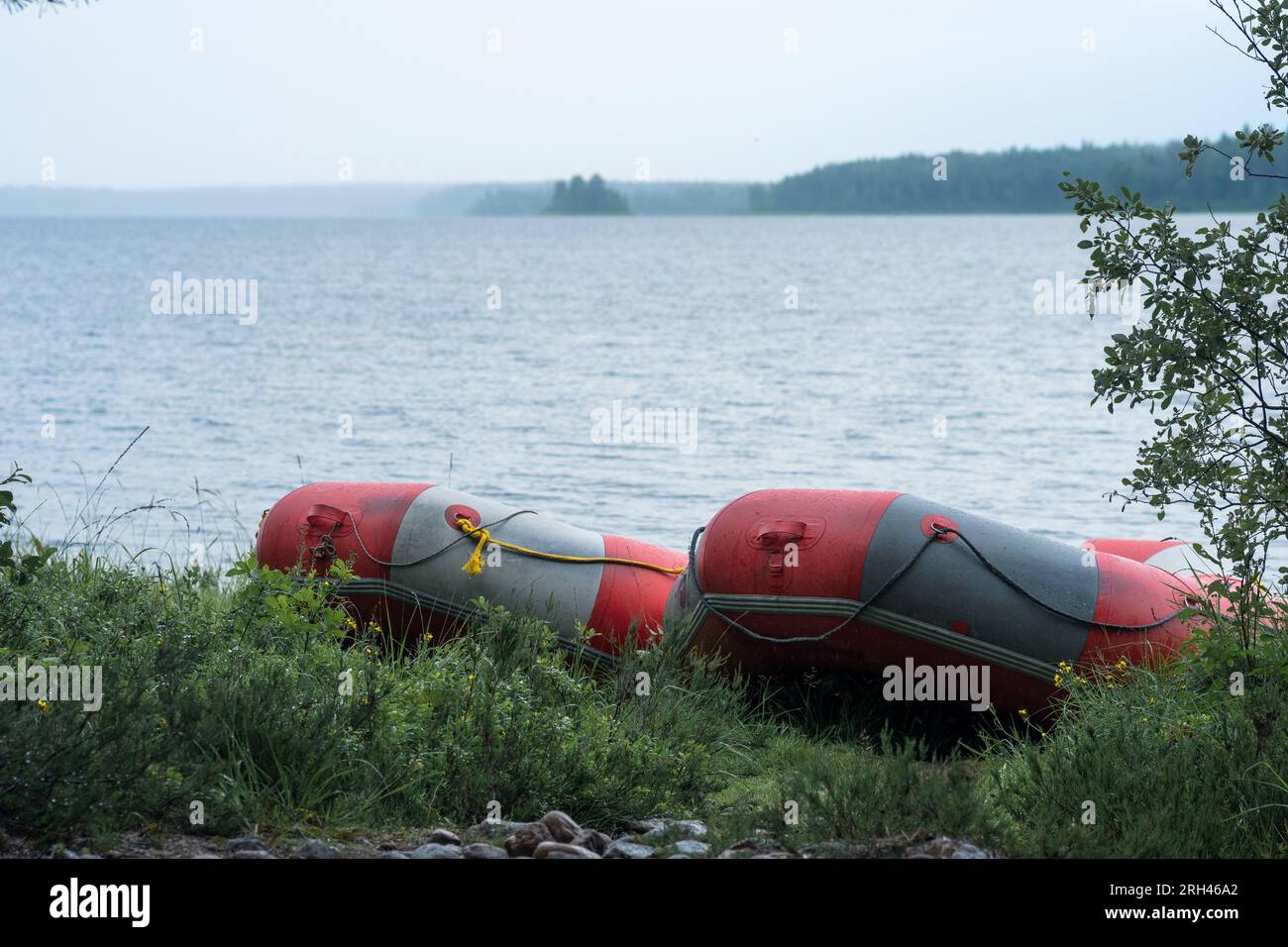 inflatable rafts is moored on the lake shore on a rainy day Stock Photo ...