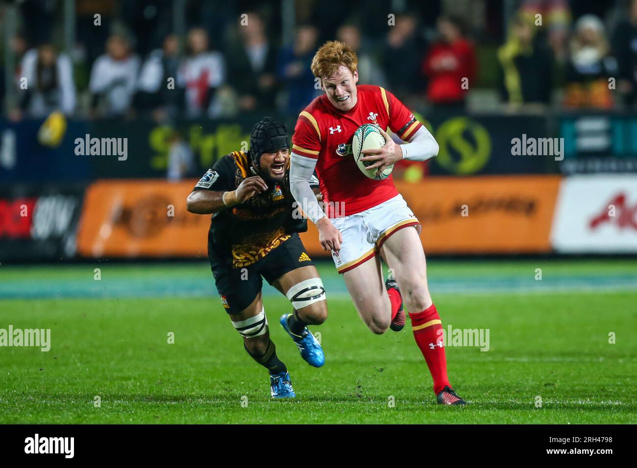 Taleni Seu of the Chiefs chases Rhys Patchell of Wales during the rugby match between the Chiefs and Wales at Waikato Stadium in Hamilton, New Zealand, Tuesday, June 14, 2016. Stock Photo