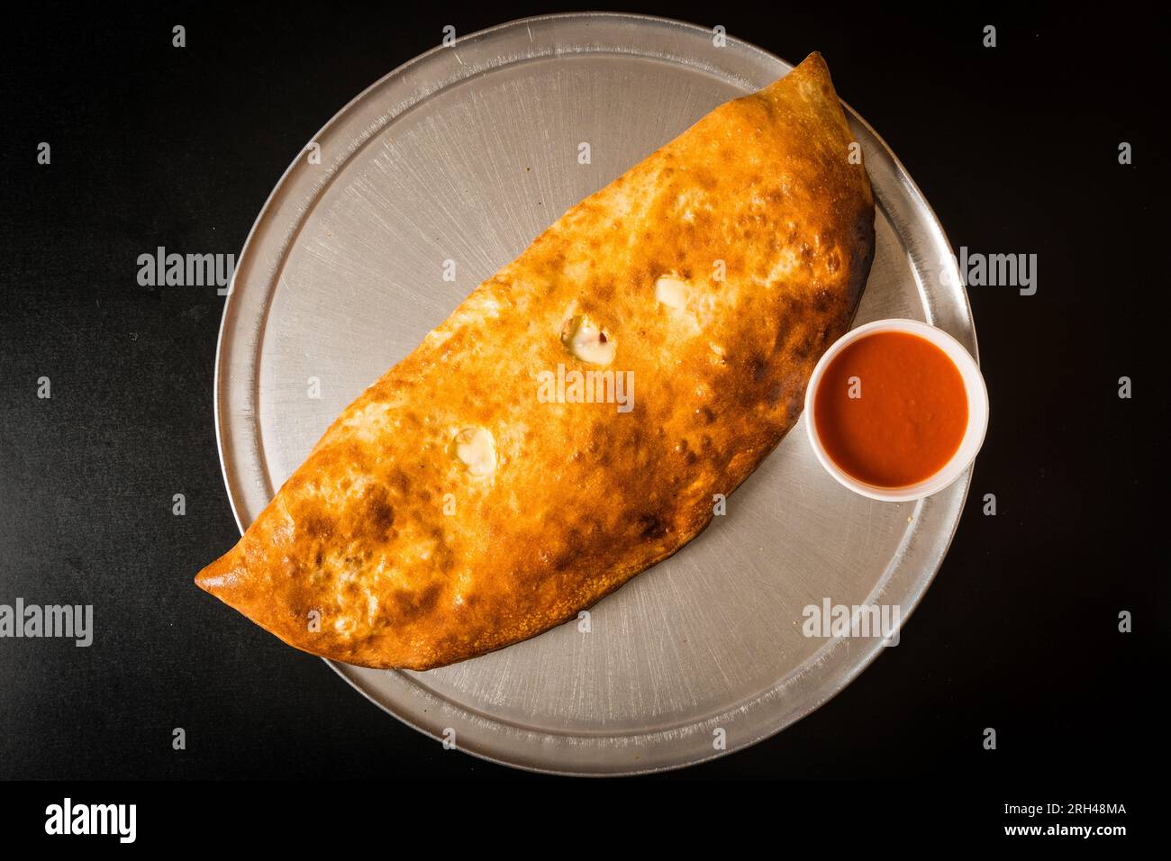 Stromboli with marinara sauce Stock Photo