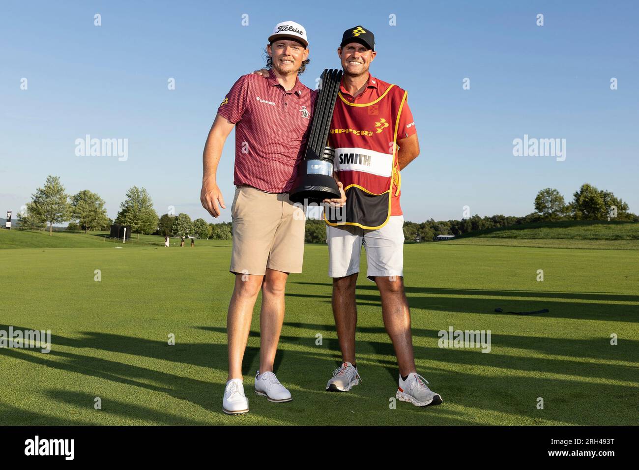 First place individual champion Captain Cameron Smith (L) of Ripper GC and  caddie Sam Pinfold (R) celebrate with the trophy after winning LIV Golf  Bedminster at the Trump National Golf Club on