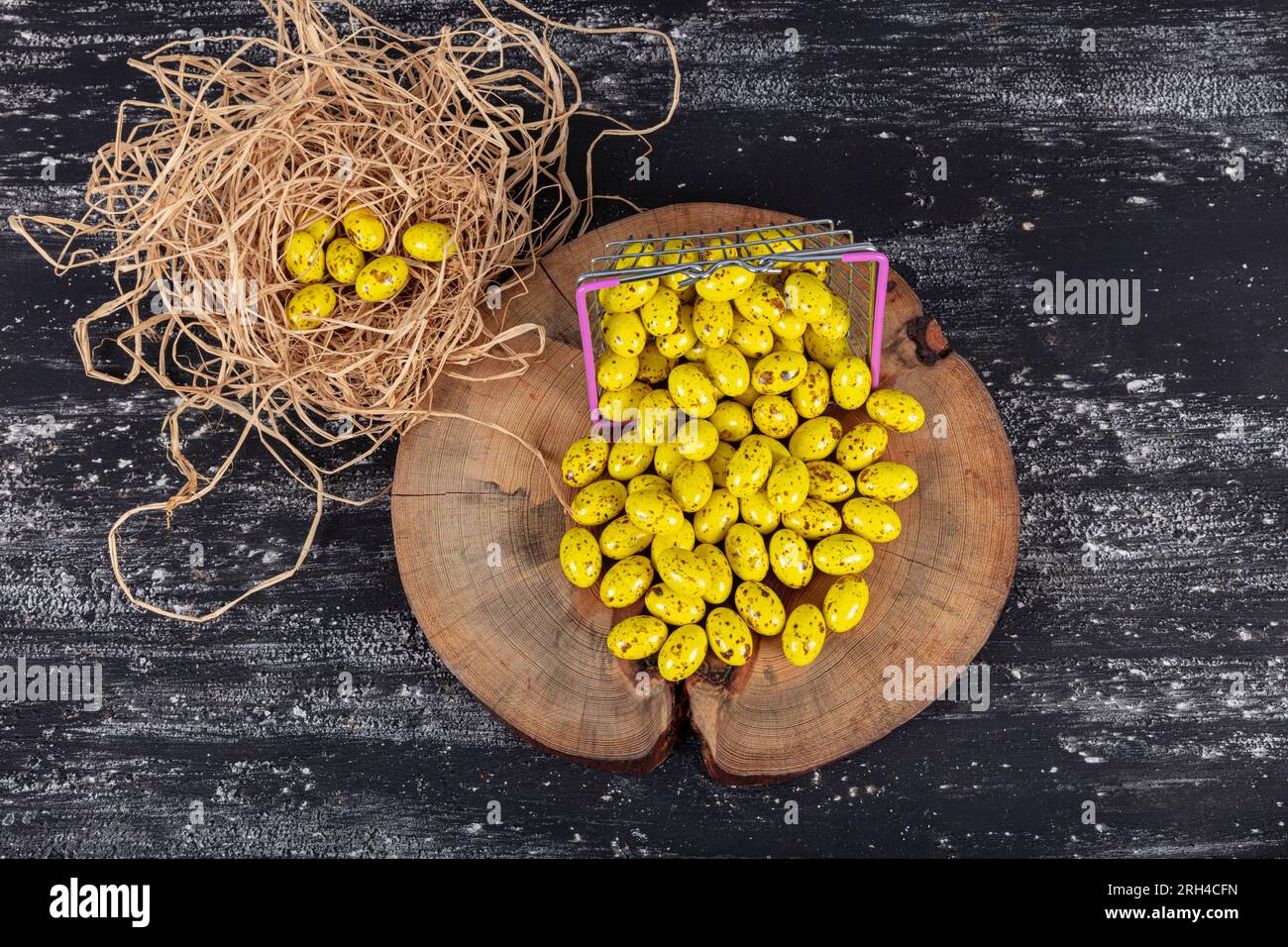 Heap of sugared almonds and hazelnuts dragees in chocolate isolated on dark background. Handmade colorful chocolate candies filled with nuts. Chocolat Stock Photo