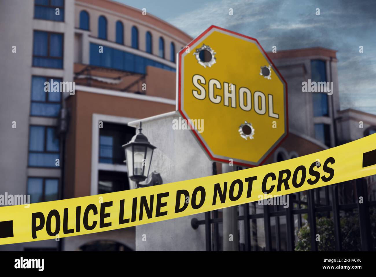 Yellow crime scene tape blocking way to school Stock Photo