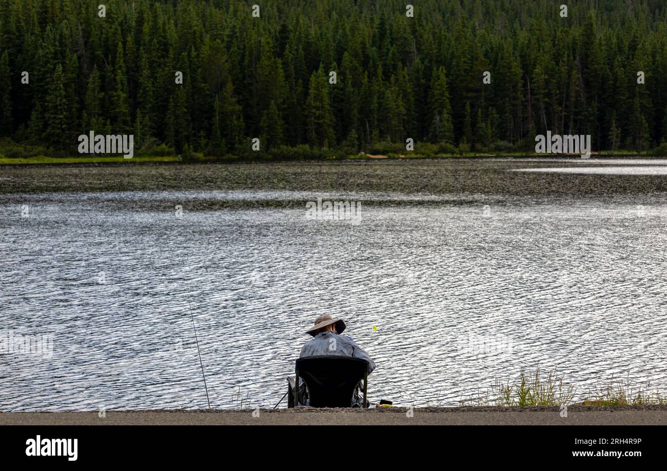 Unrecognizable fisherman on Echo Lake in the Rocky Mountains, Colorado Stock Photo
