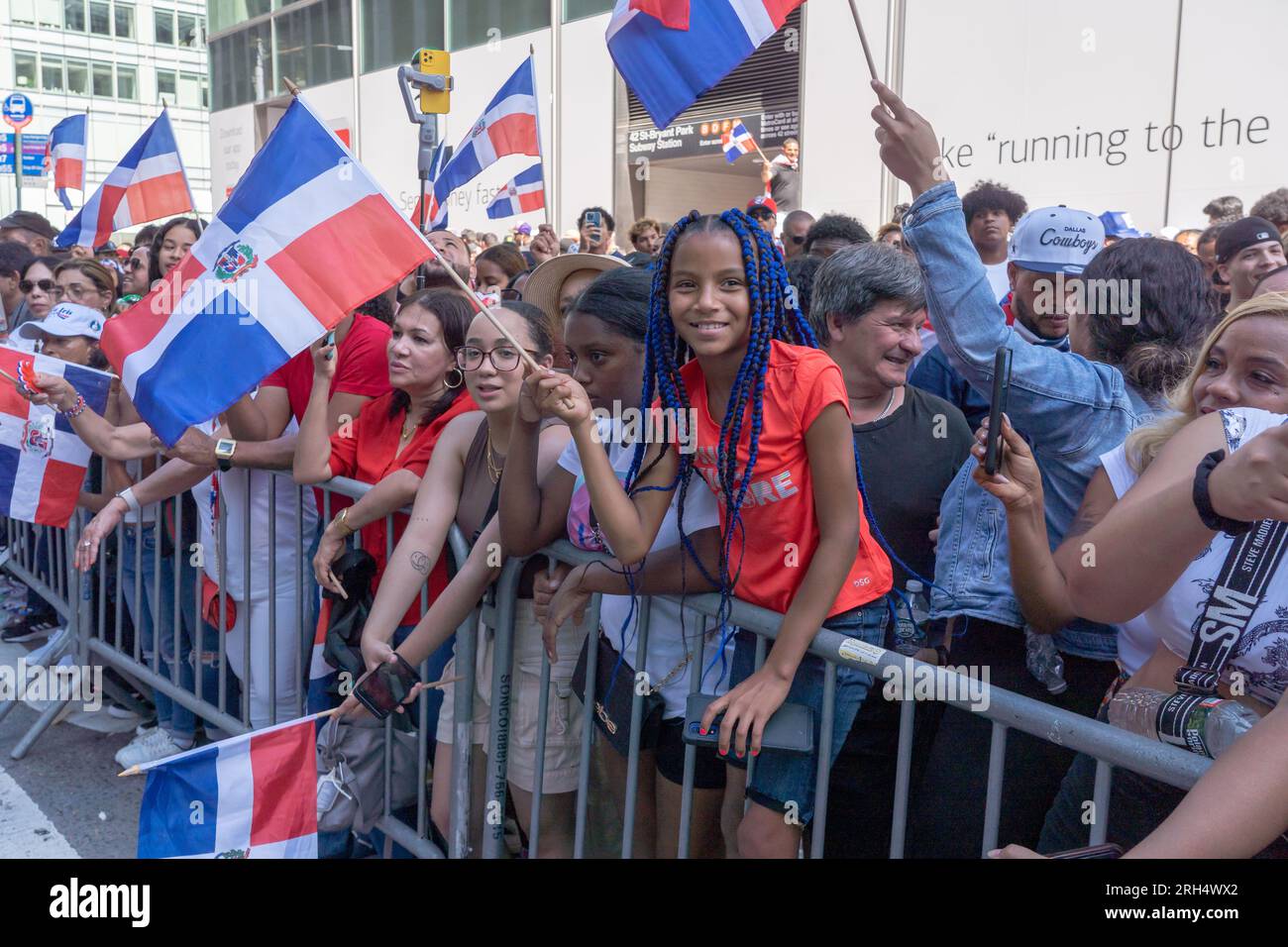 New York, United States. 13th Aug, 2023. NEW YORK, NEW YORK - AUGUST 13: Spectators with Dominican Republic flags watch the marchers at the Dominican Day Parade on 6th Avenue on August 13, 2023 in New York City. The National Dominican Day Parade celebrated 41 years of marching on Sixth Avenue in Manhattan. The parade celebrates Dominican culture, folklore, and traditions. Credit: Ron Adar/Alamy Live News Stock Photo