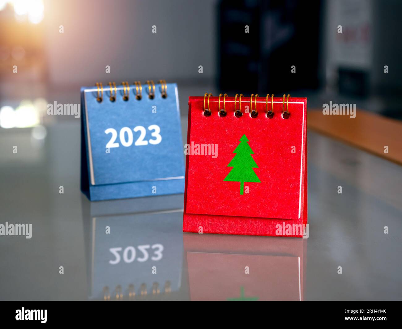 Green Christmas tree graphic icon on red folding desk calendar standing ...