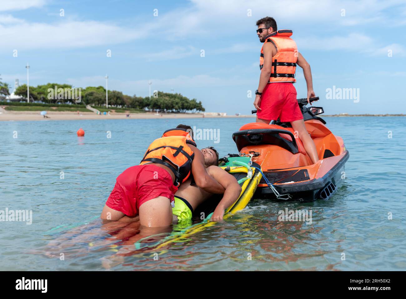 Photo with copy space of lifeguards rescue a man in the sea using a jet ...