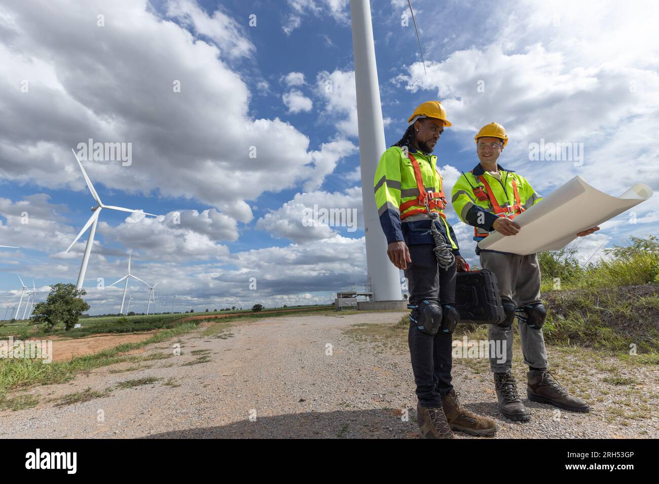 Wind turbine engineer technician male team working service maintenance survey construction site. Eco power energy generator for sustainable people wor Stock Photo