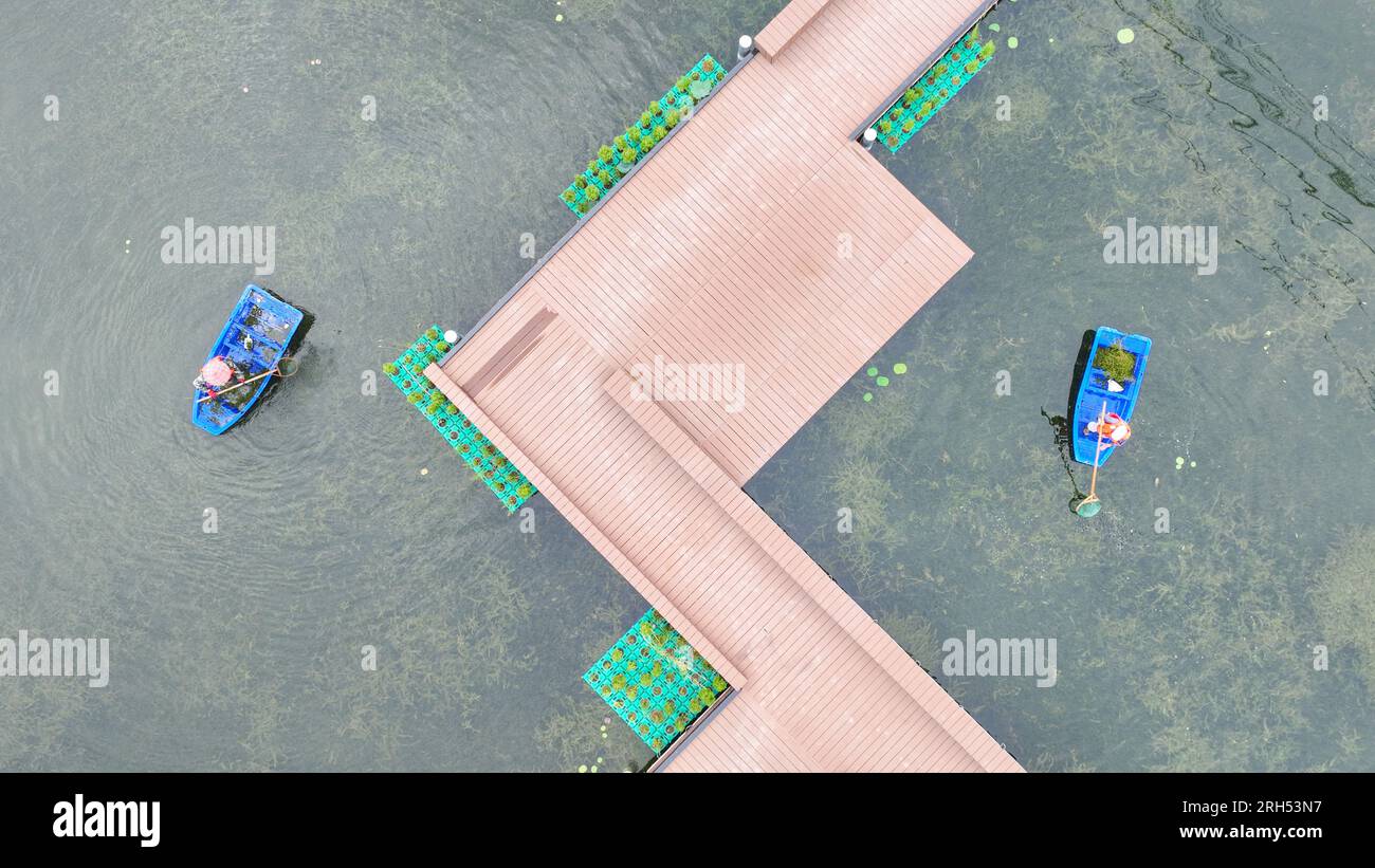 HUZHOU, CHINA - AUGUST 13, 2023 - River cleaners salvage floating objects by boat in Lianhe village, Kangqian Street, Deqing County, Huzhou city, East Stock Photo