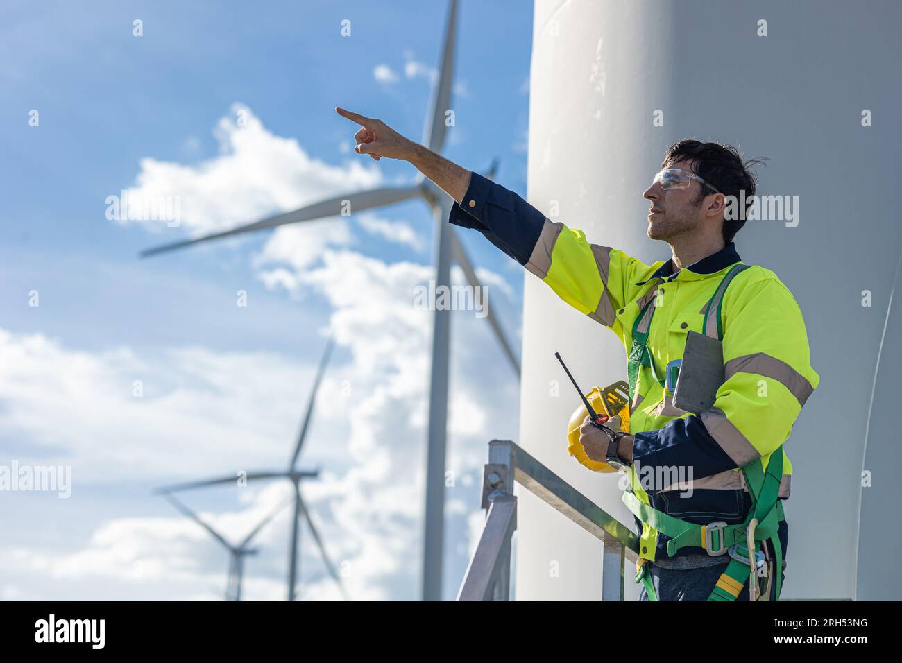 Wind turbine technician checking service. Engineer team professional working maintenance clean power generator system Stock Photo