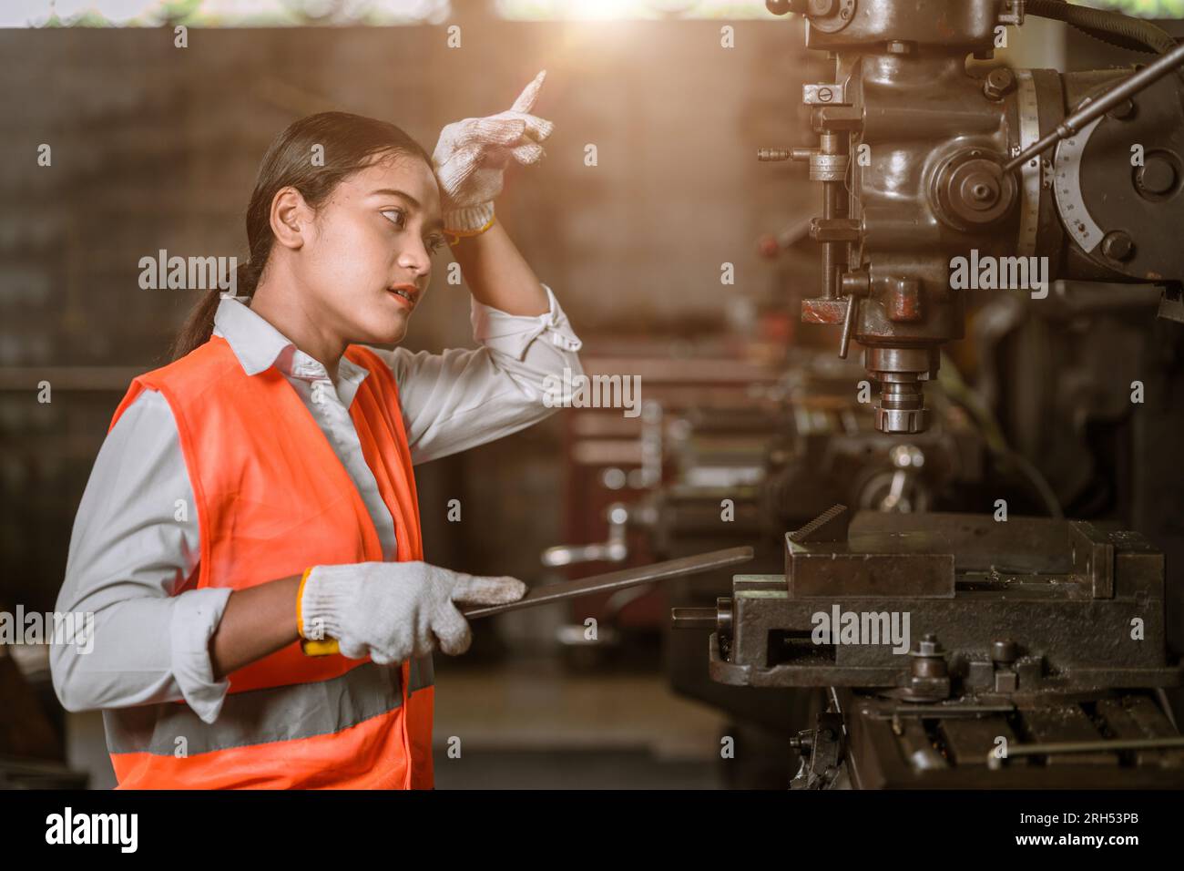 tired stress young woman worker sweating hard working in danger heavy metal industry Stock Photo