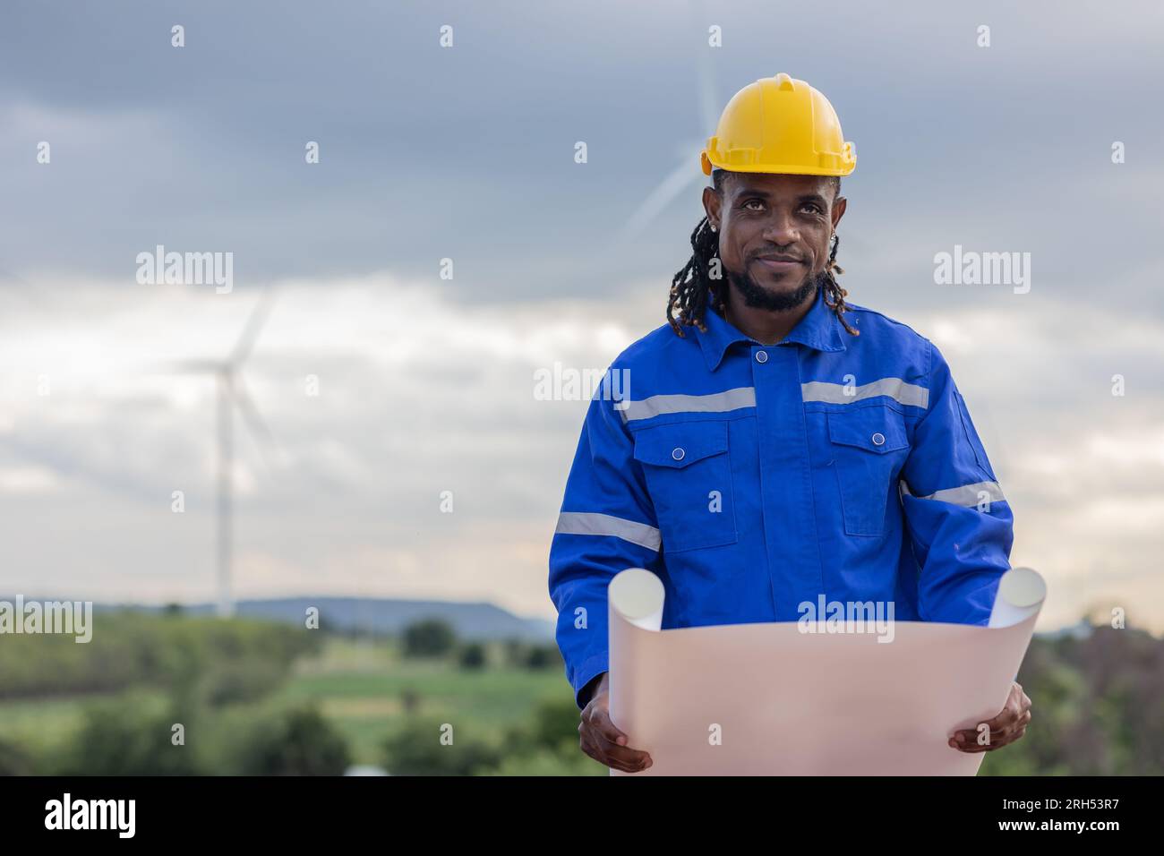 Wind turbine technician checking service. Black African Engineer professional working maintenance clean power generator system Stock Photo
