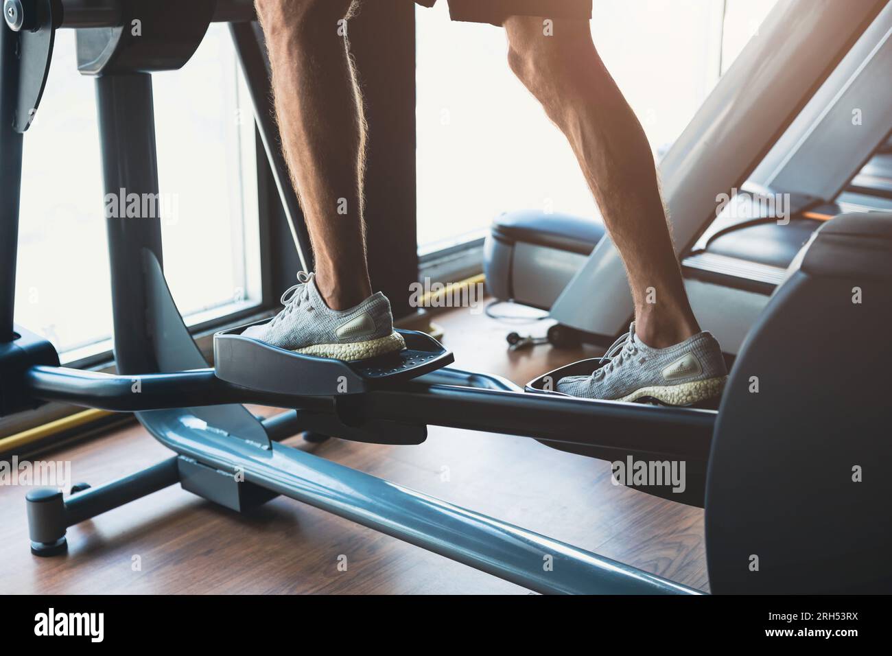 closeup healthy fitness people man sport strength exercise activity at gym on eclipse climbs machine Stock Photo