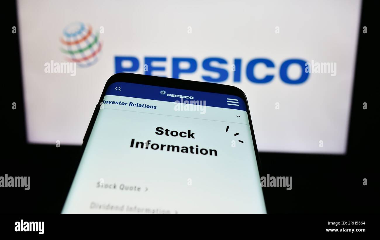 Smartphone with website of US beverage and snack company PepsiCo Inc. on screen in front of business logo. Focus on top-left of phone display. Stock Photo