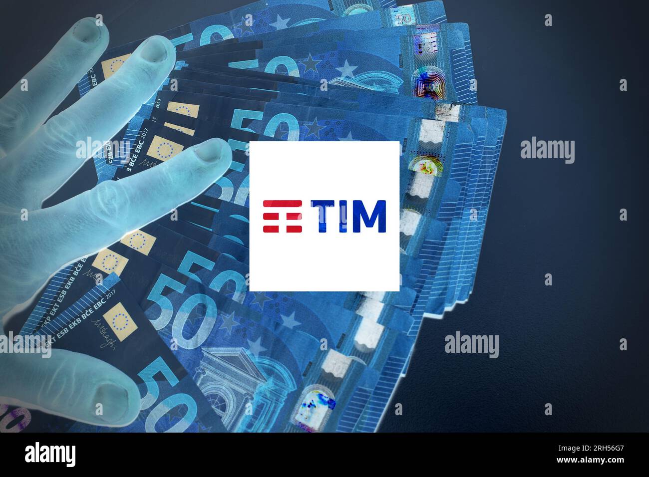 Hand with money with the symbol TIM , concept of corporation sold to KKR. Stock Photo