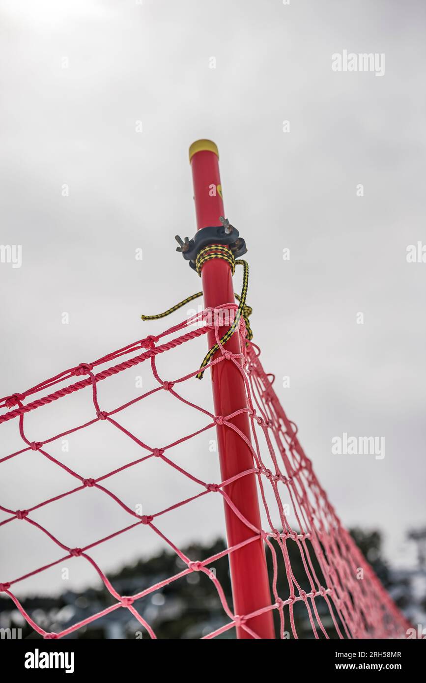 A Detail of orange plastic barrier on ski slope Stock Photo