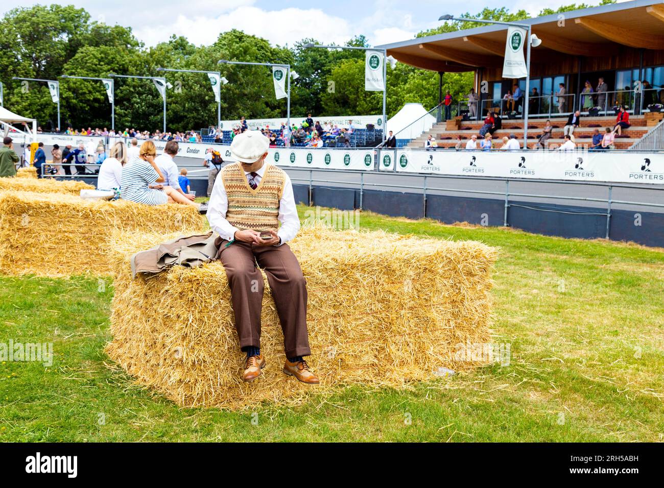 Dressed up man sitting on a hay bale during World Cycling Revival Festival 2018, London, UK Stock Photo