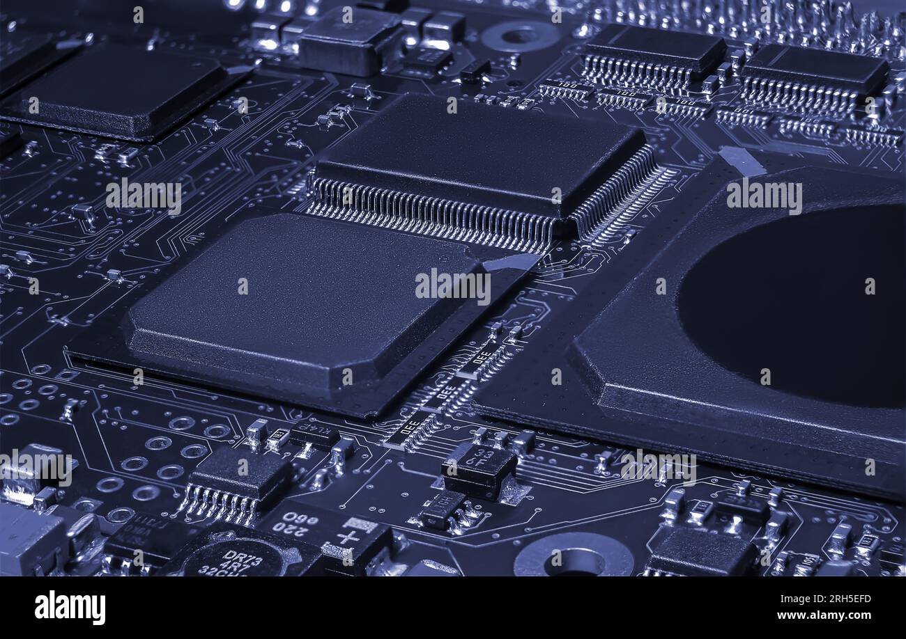 Intricate circuit board with computer hardware, showcasing complexity of electronics industry. Stock Photo