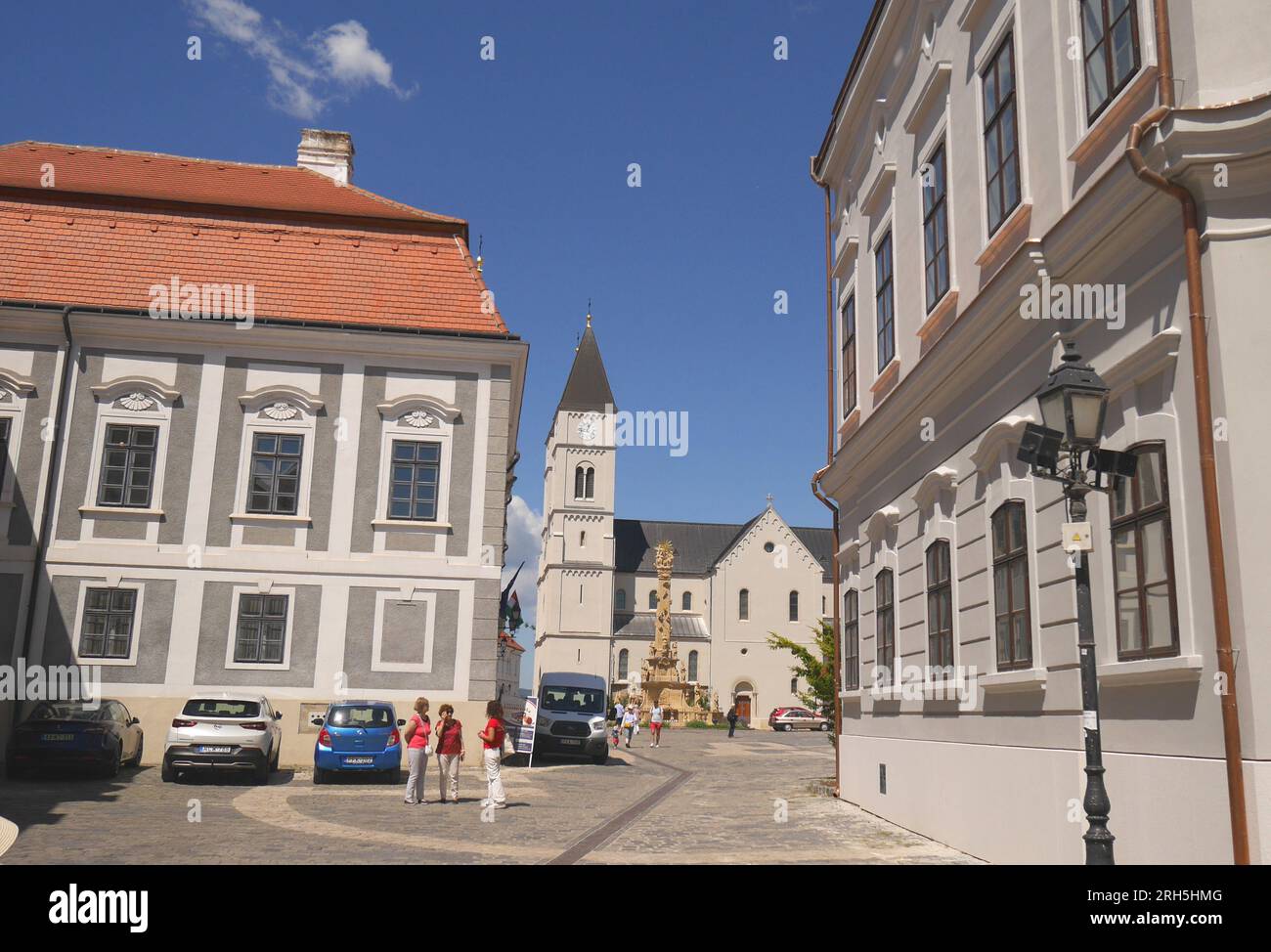 Looking along Var utca, Castle Street, towards Holy Trinity Square with St Michael’s Church and the Holy Trinity Column, Veszprem, Hungary Stock Photo