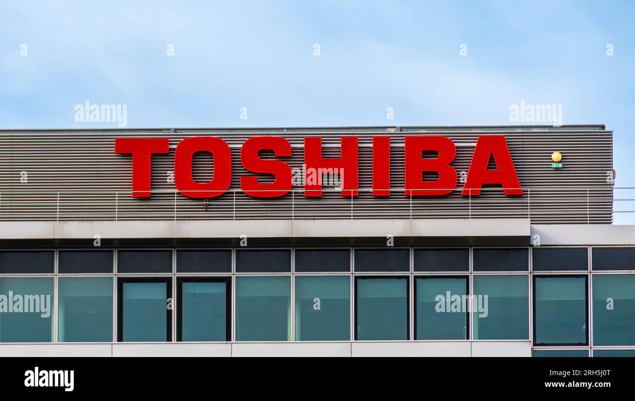 Sign and logo at the top of a building of a Toshiba subsidiary. Toshiba is a Japanese conglomerate manufacturer of electronic and computer hardware Stock Photo