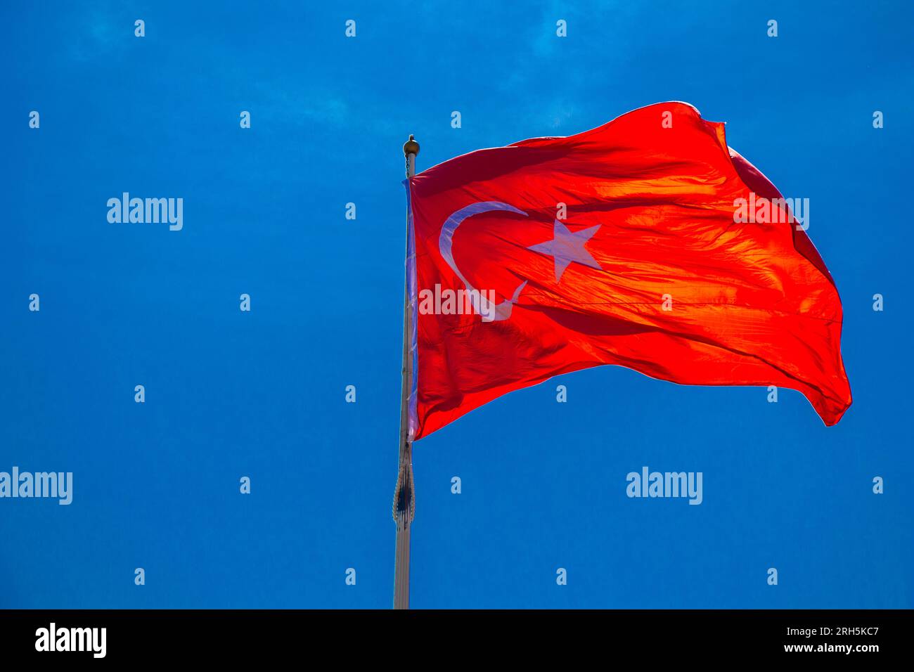 Turkish national flag with white star and moon in sky Stock Photo