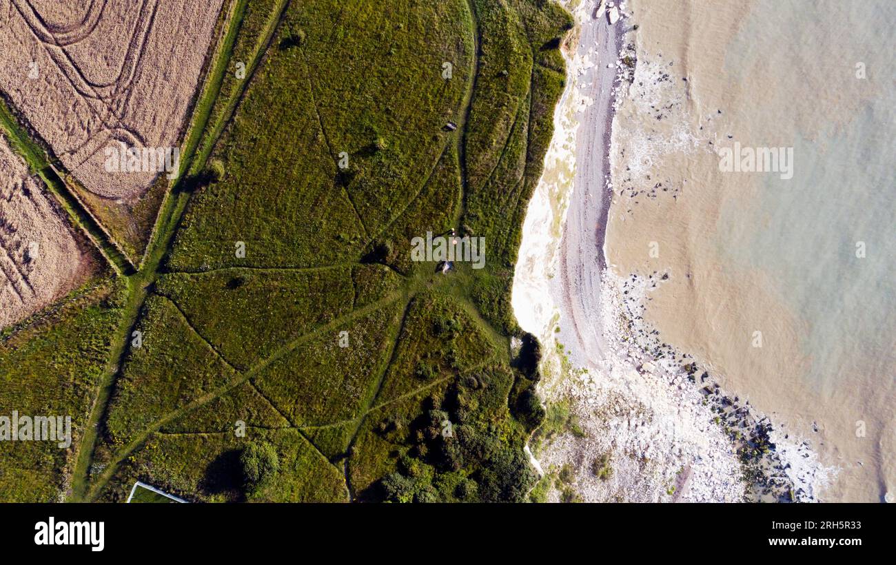 Aerial image from a drone, flying above the clifftop edge, looking down, at St Margret's Bay